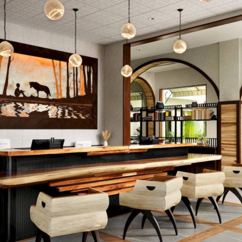 A modern reception area with wooden furniture, arched shelves, hanging lights, and a large wall painting depicting a pastoral scene.